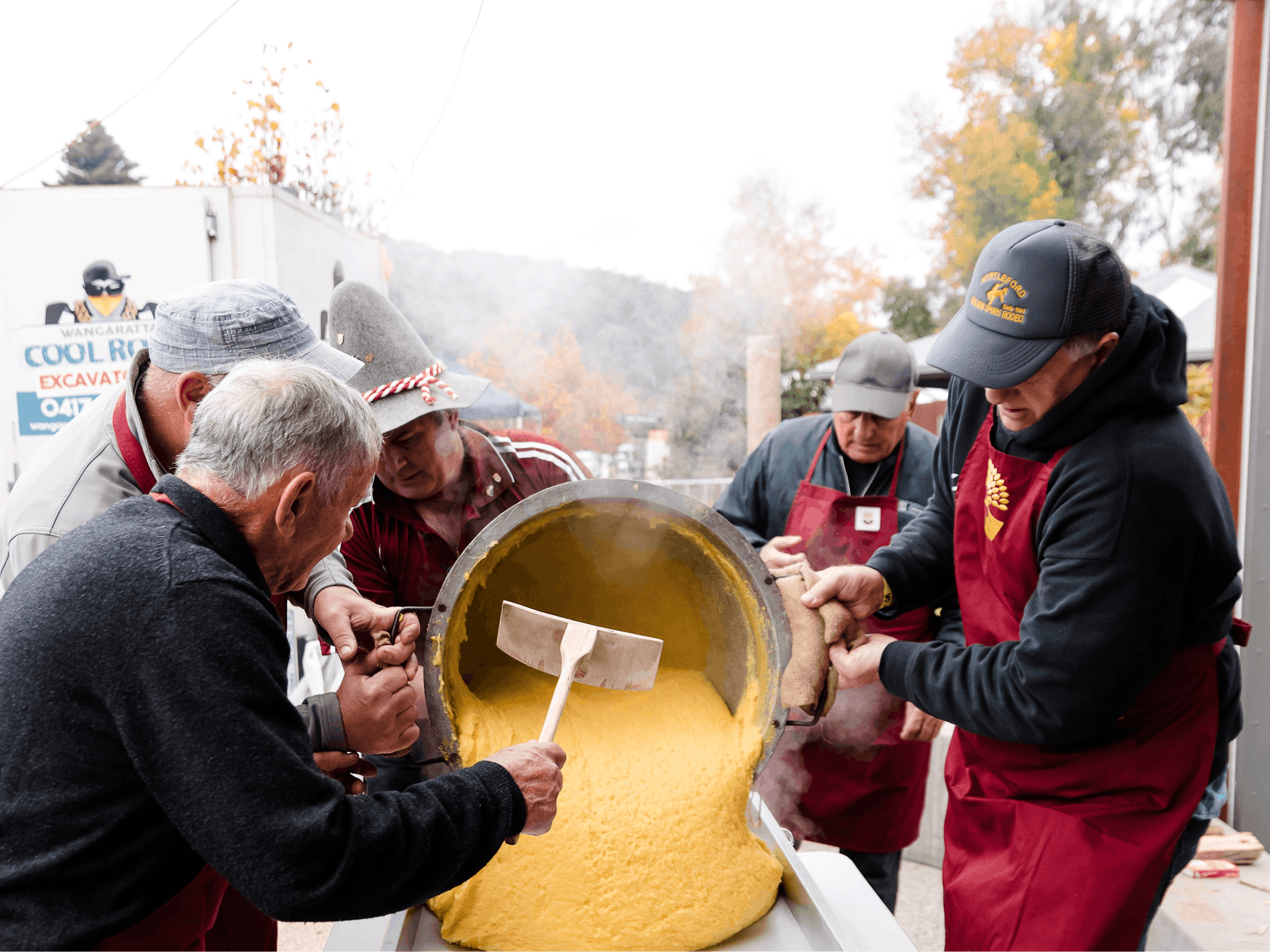 Trentini men pouring polenta