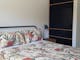 Bedroom with ensuite and two banks of open shelving, for your convenience