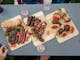Three wooden trays with assorted grilled meats