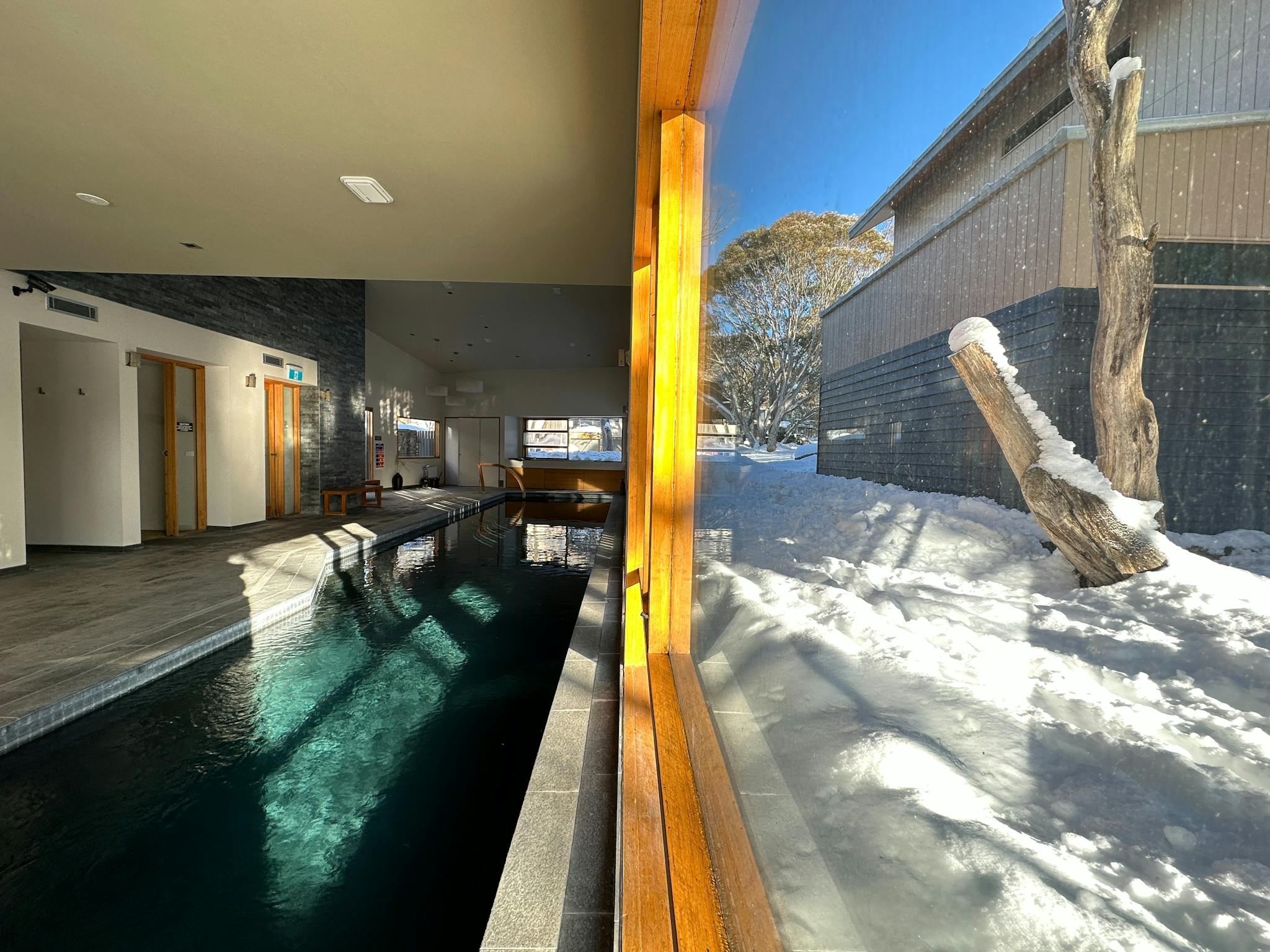 Indoor Lap Pool facing a window looking out onto snow