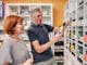 Couple in the Pepo Farms shop holding a bottle of cold pressed oil