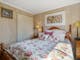 A main bedroom with a bed in the middle and floral sheets