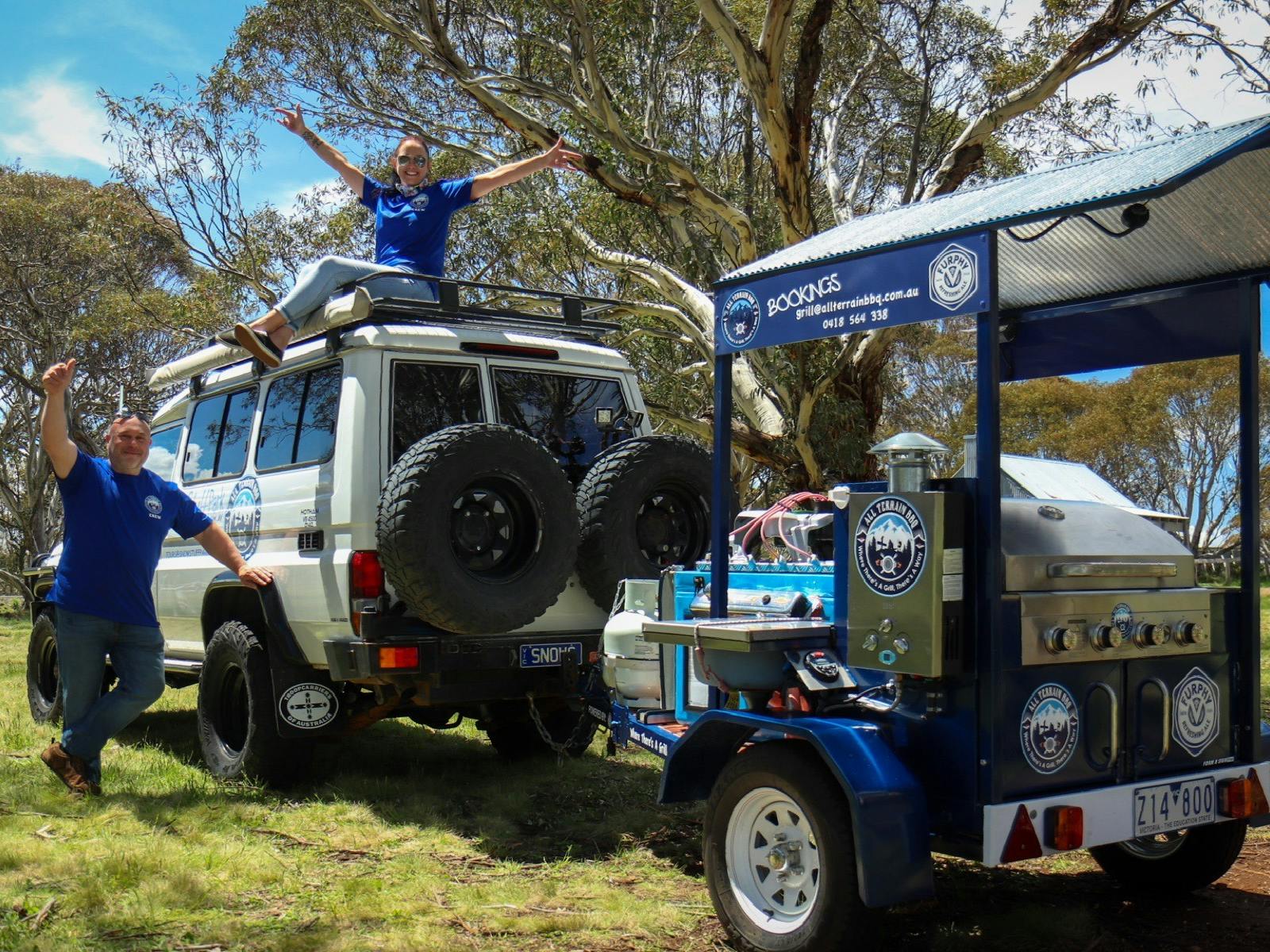 Grill trailer with two people posing for the photo