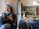 girl sitting in windowseat reading book