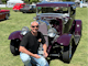 Man posing with a vintage car