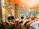 Lounge room with chairs and a stone wall with a fireplace