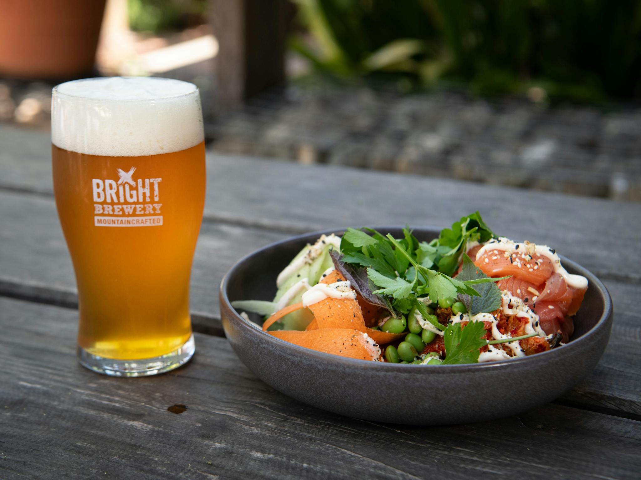A glass of Bright Brewery beer with a nourishing bowl of food