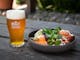 A glass of Bright Brewery beer with a nourishing bowl of food