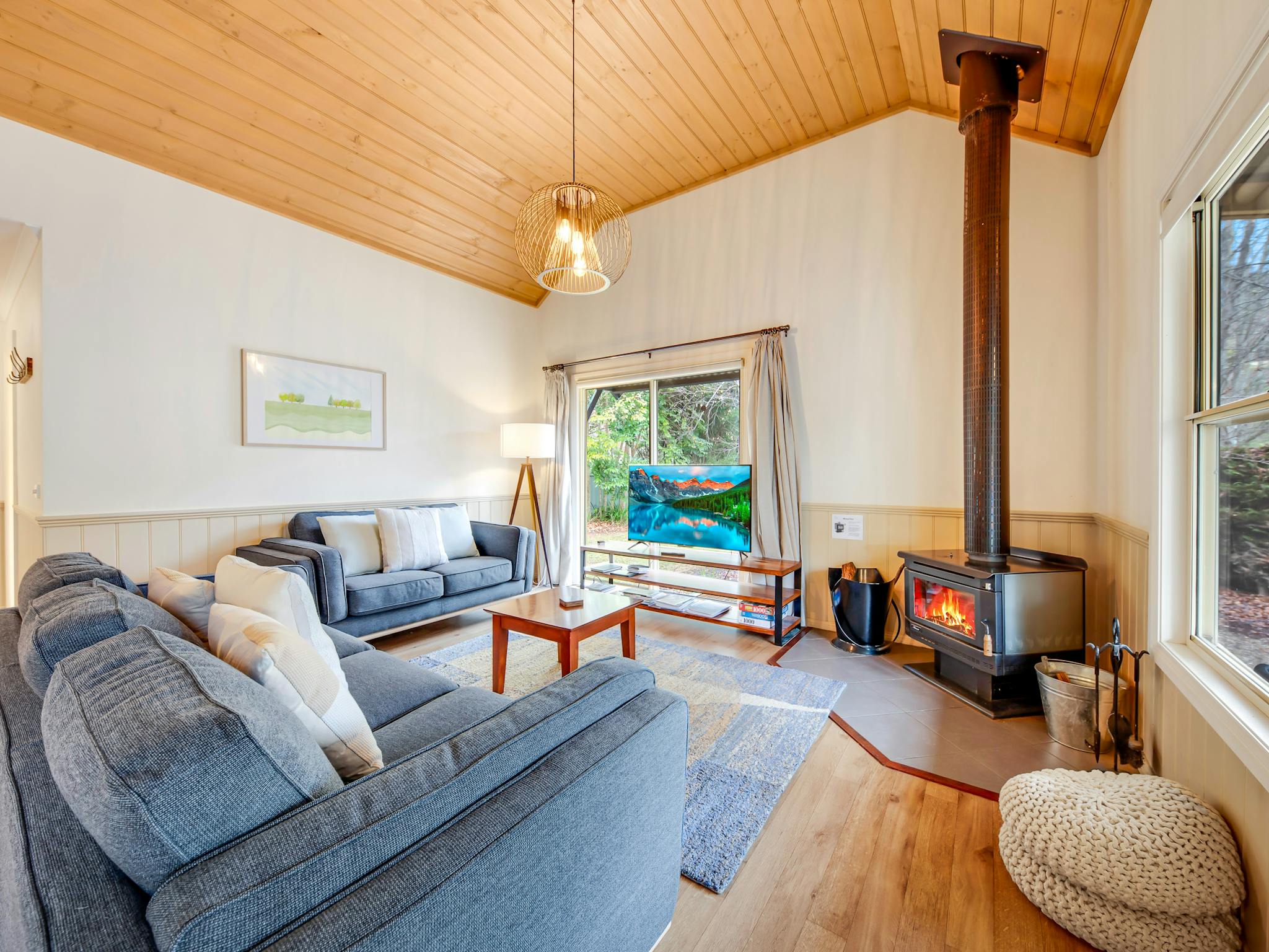 Lounge area with a small fireplace, television, couches and tea table