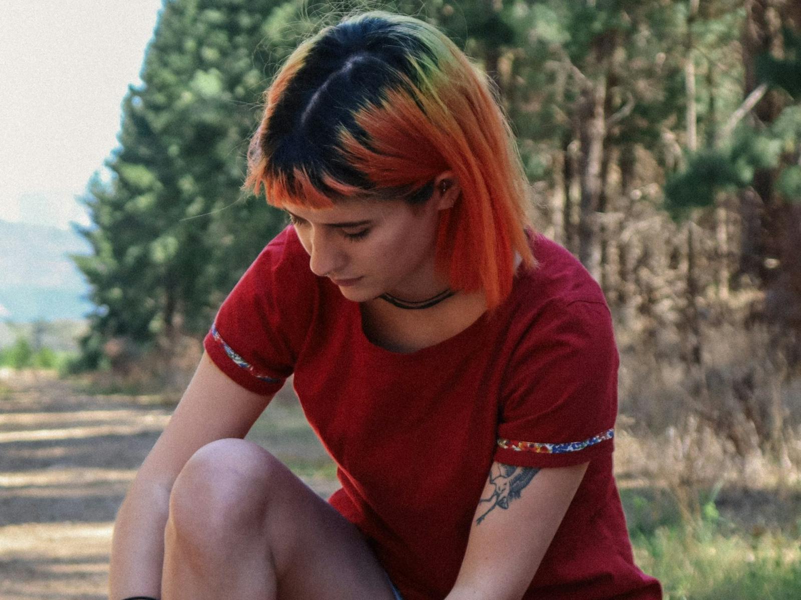 model tying her shoe laces wearing a fitted tee