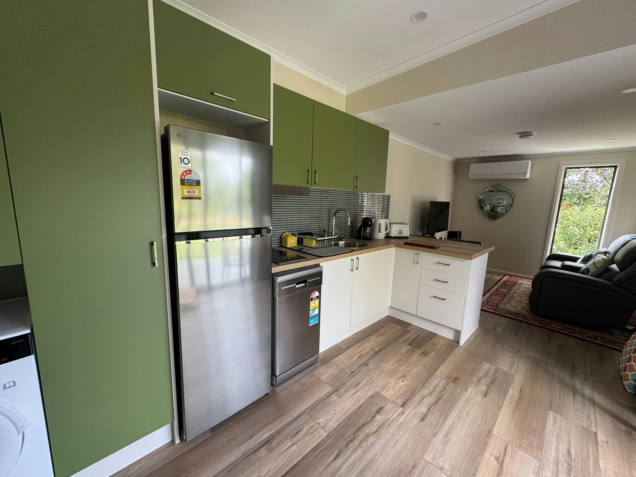 Kitchen with lounge in the background