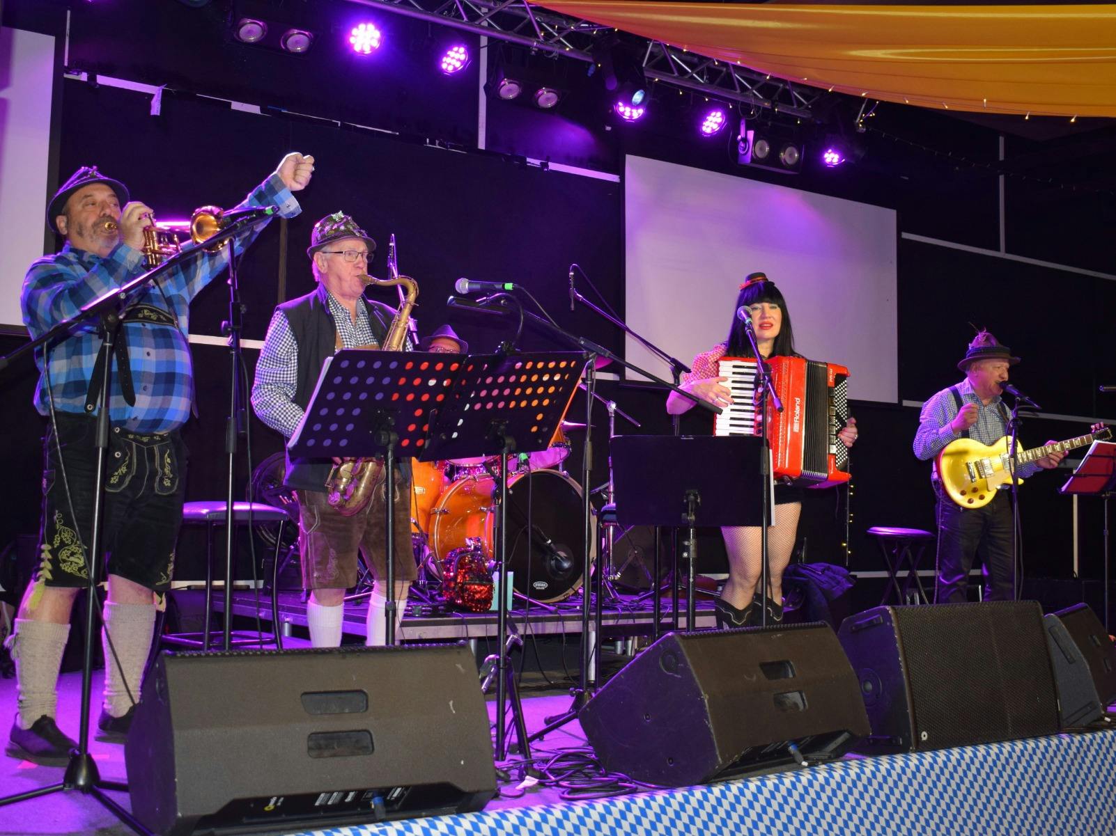 Photo of band of four people, trumpet, saxophone, accordion and bass guitar, Oompah music