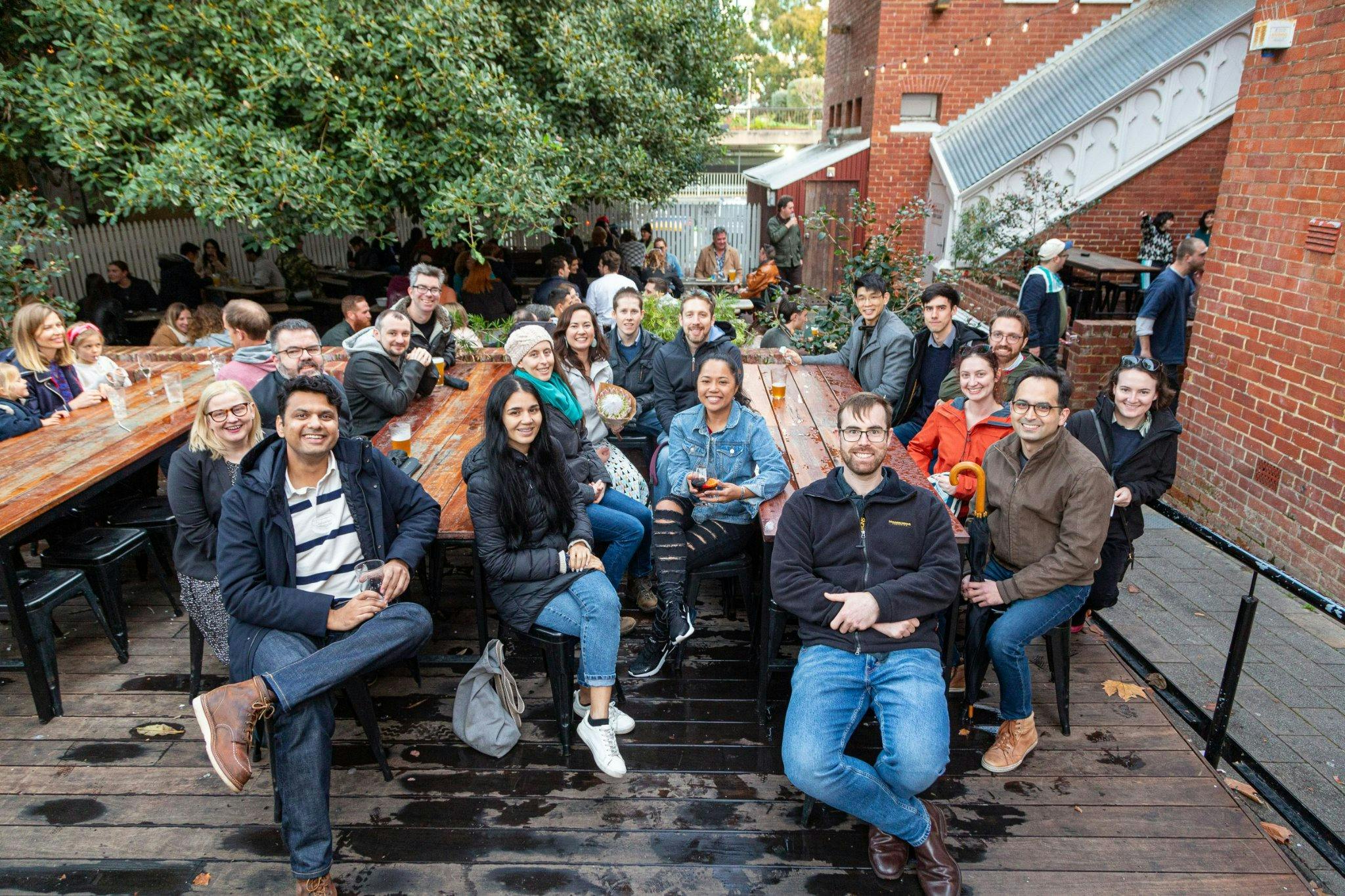 Large group walking tour posing for a photo in a Perth bar