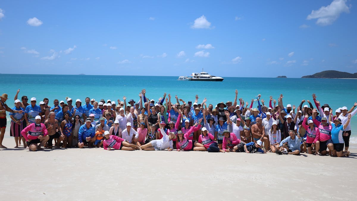 Group photo of 150 swimmers, guests and volunteers on the beach at Whitehaven Beach