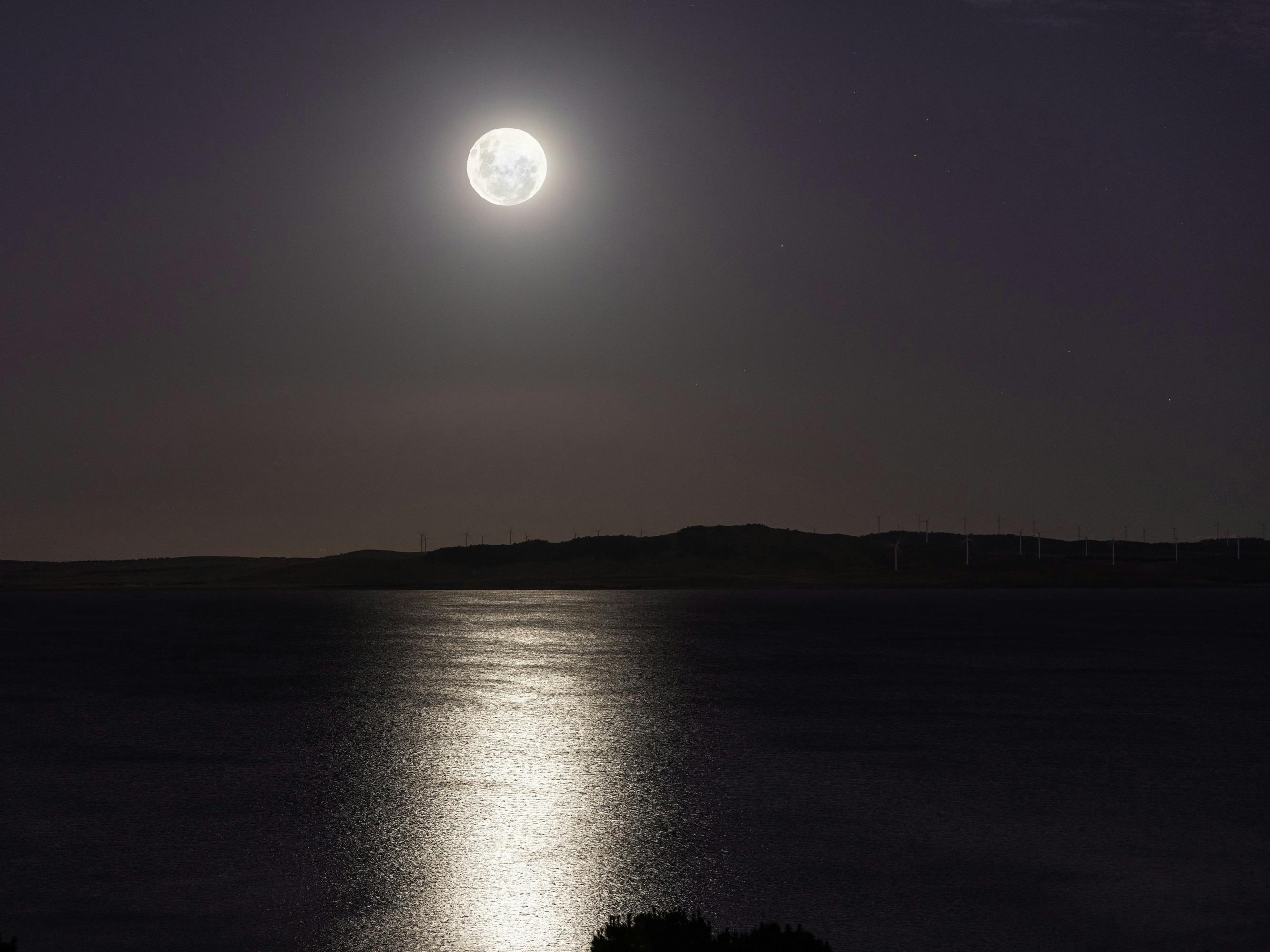 Moon over lake George and wind turbines