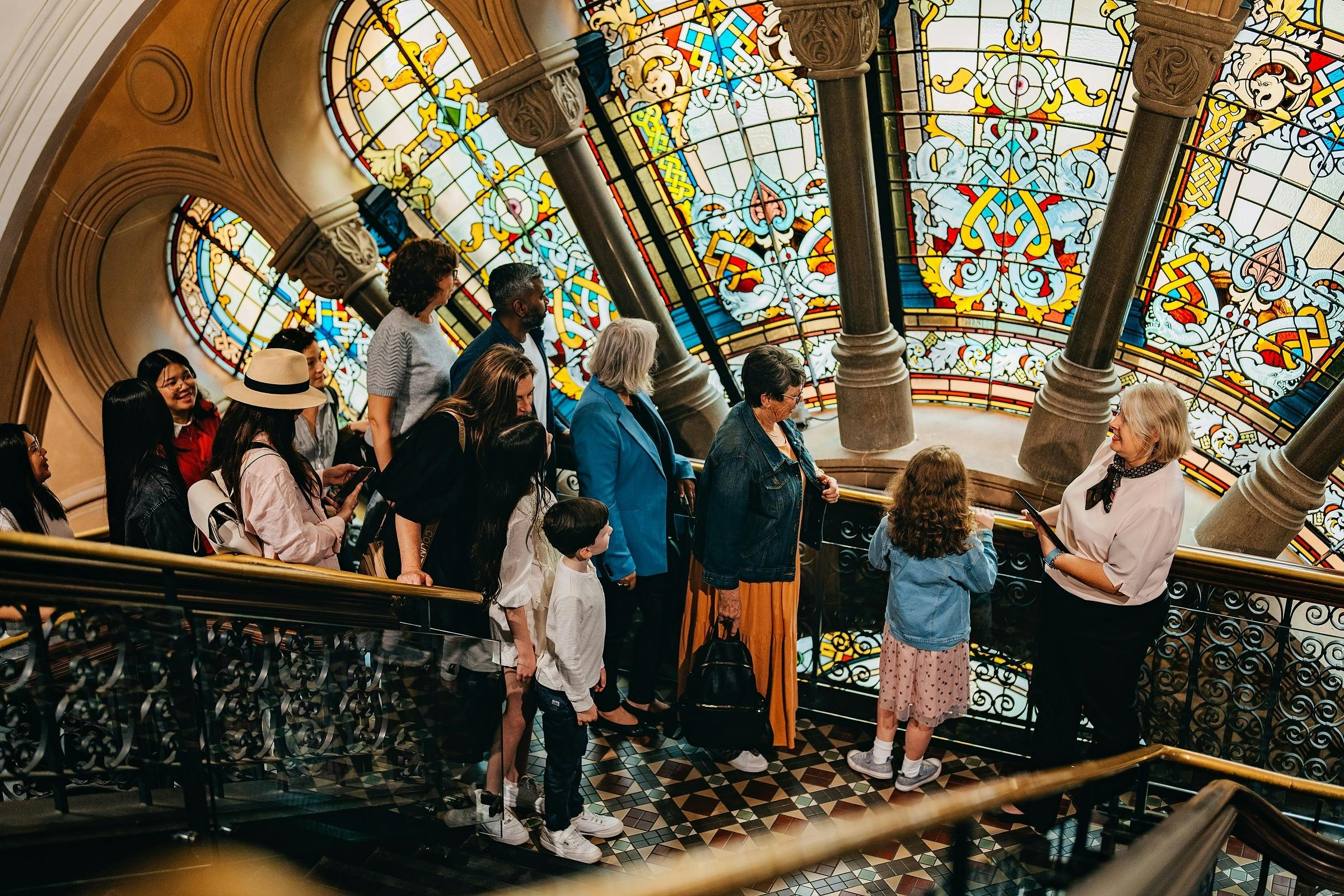 A QVB History Tour group at the stained glass window