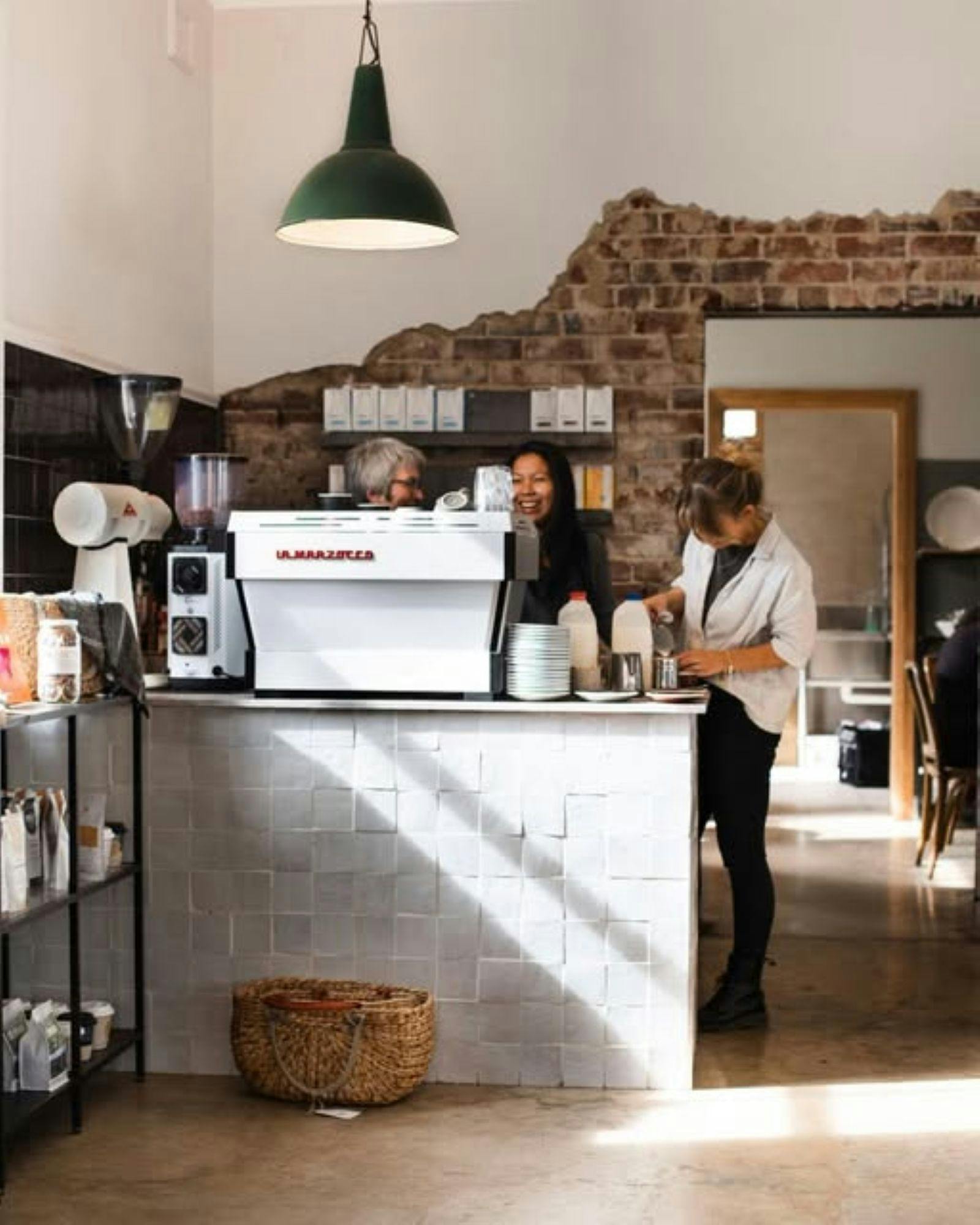 Making coffee at the front counter
