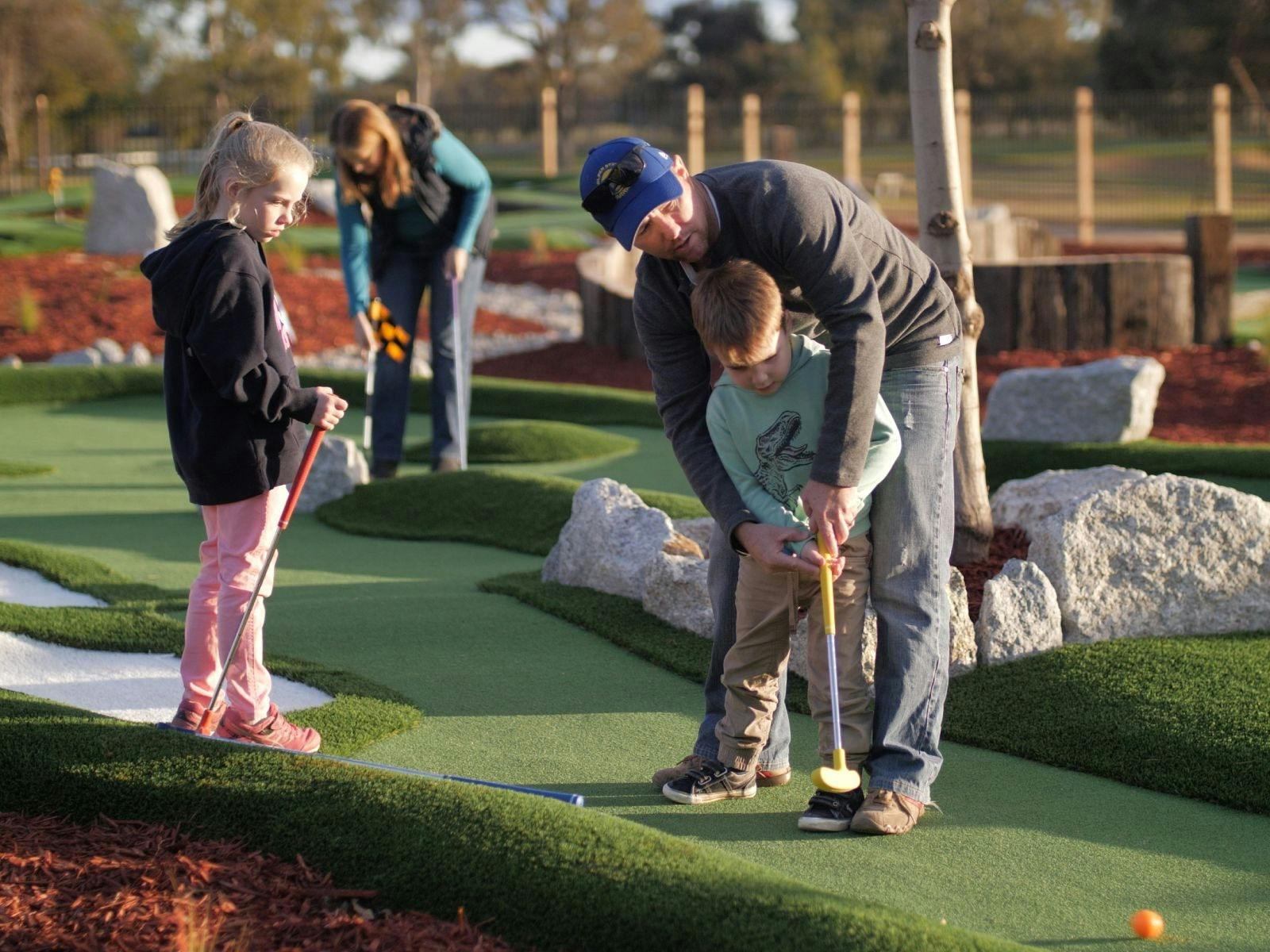 Family playing Mini Golfd
