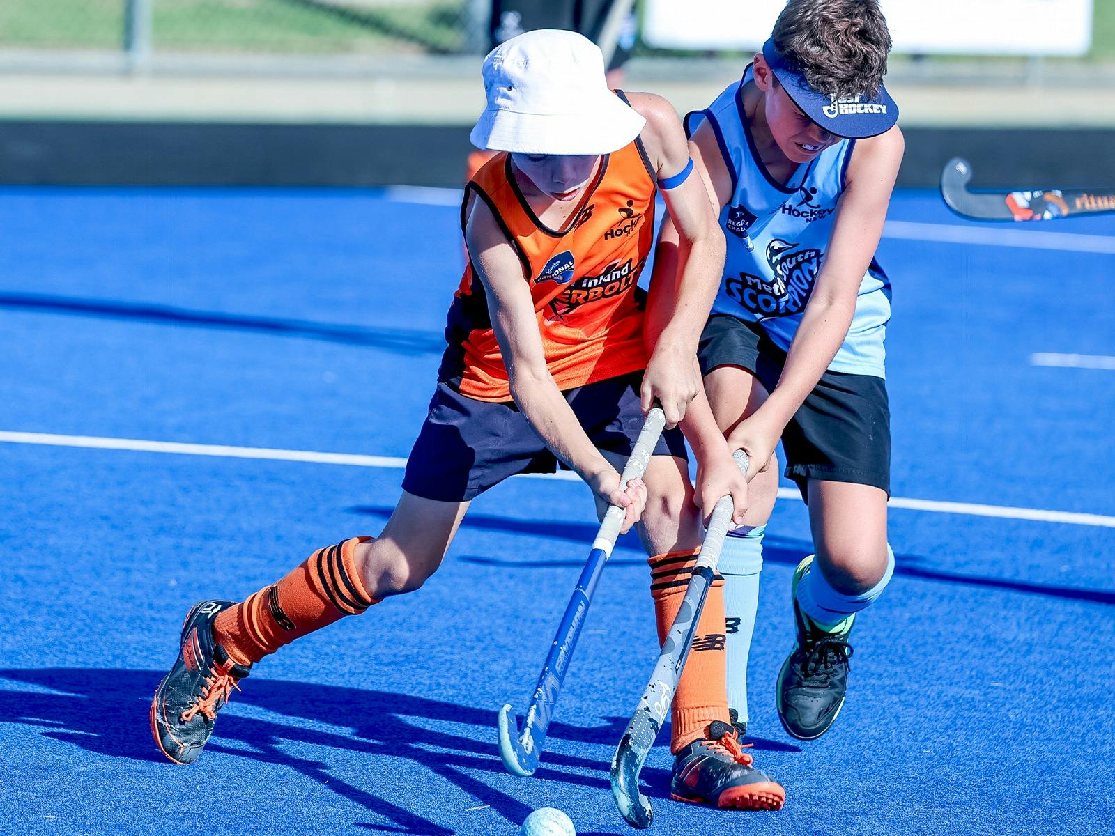 Two Young Boys Competing for the Hockey Ball