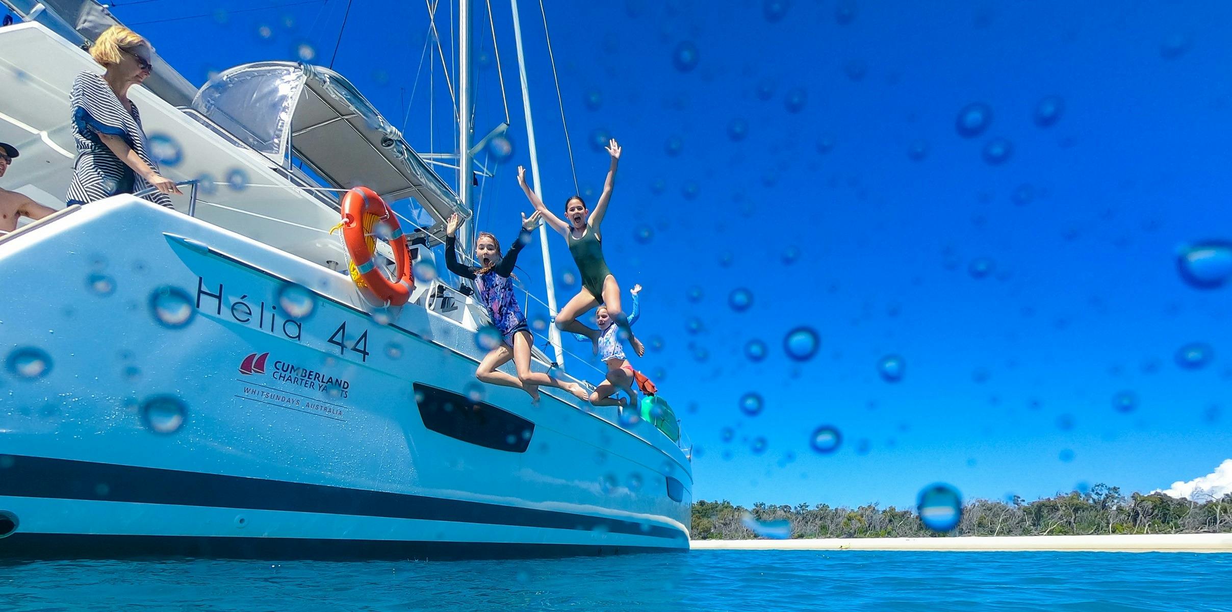 Kids jumping off the side of boat