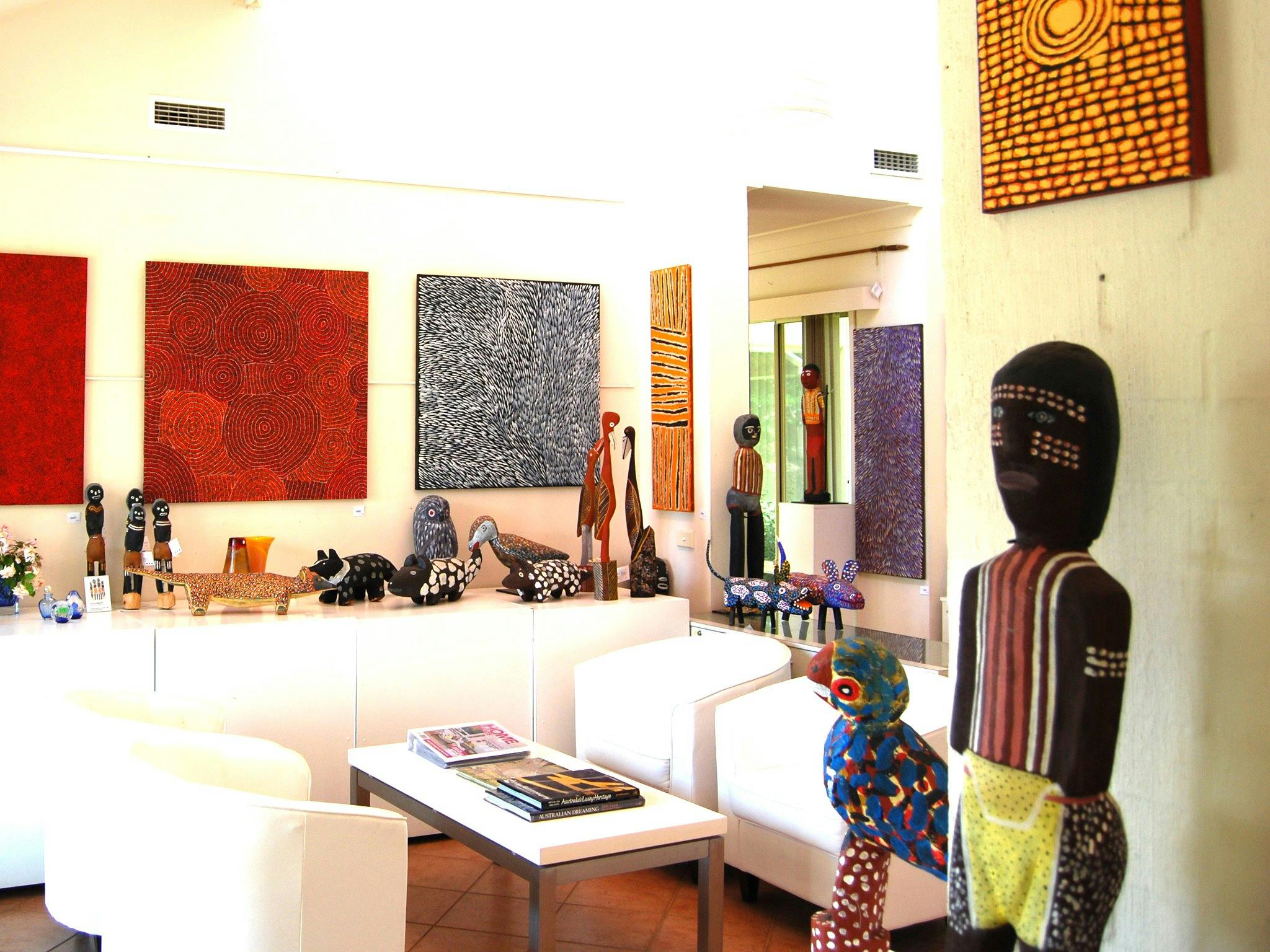 Handcrafted carvings and original paintings by Papunya and Utopia artists.