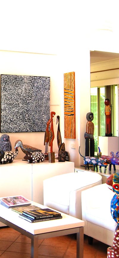 Handcrafted carvings and original paintings by Papunya and Utopia artists.