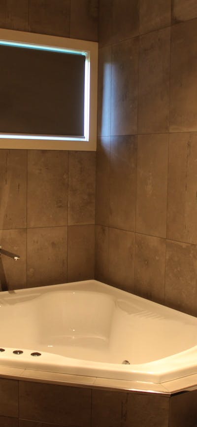 Corner spa bath in main bathroom