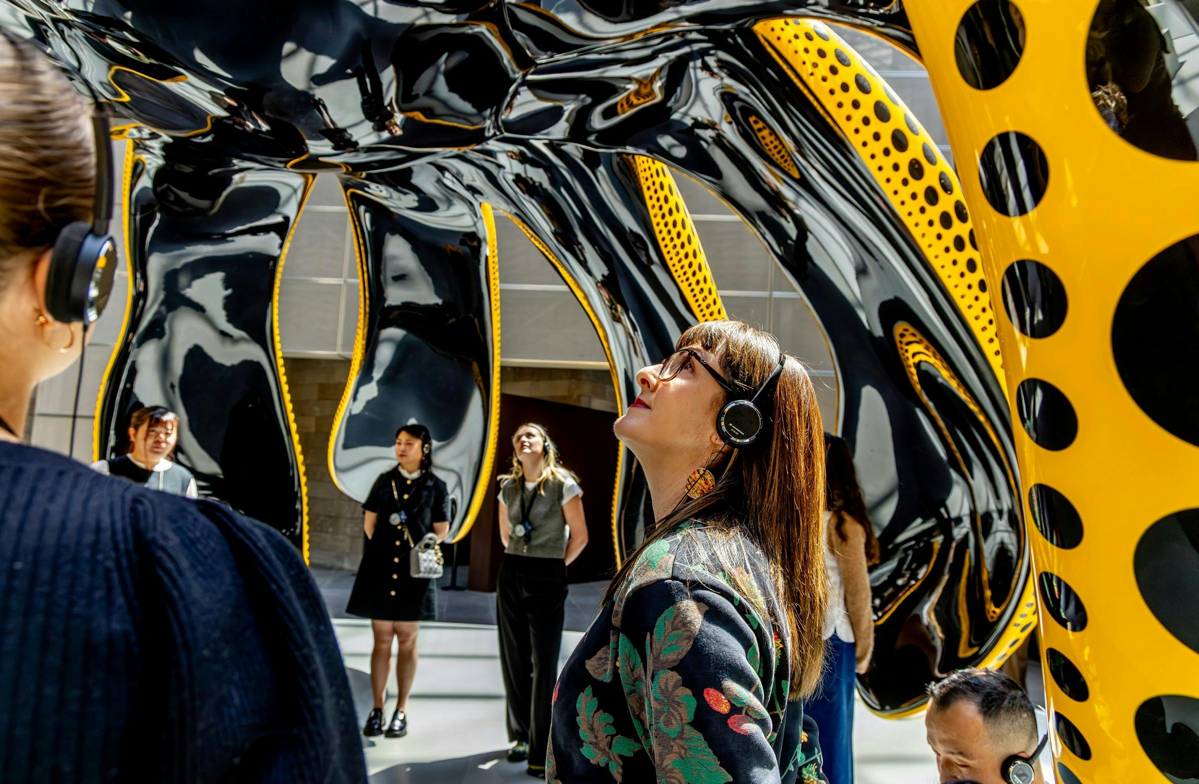 Visitors wearing headphones at the National Gallery of Victoria