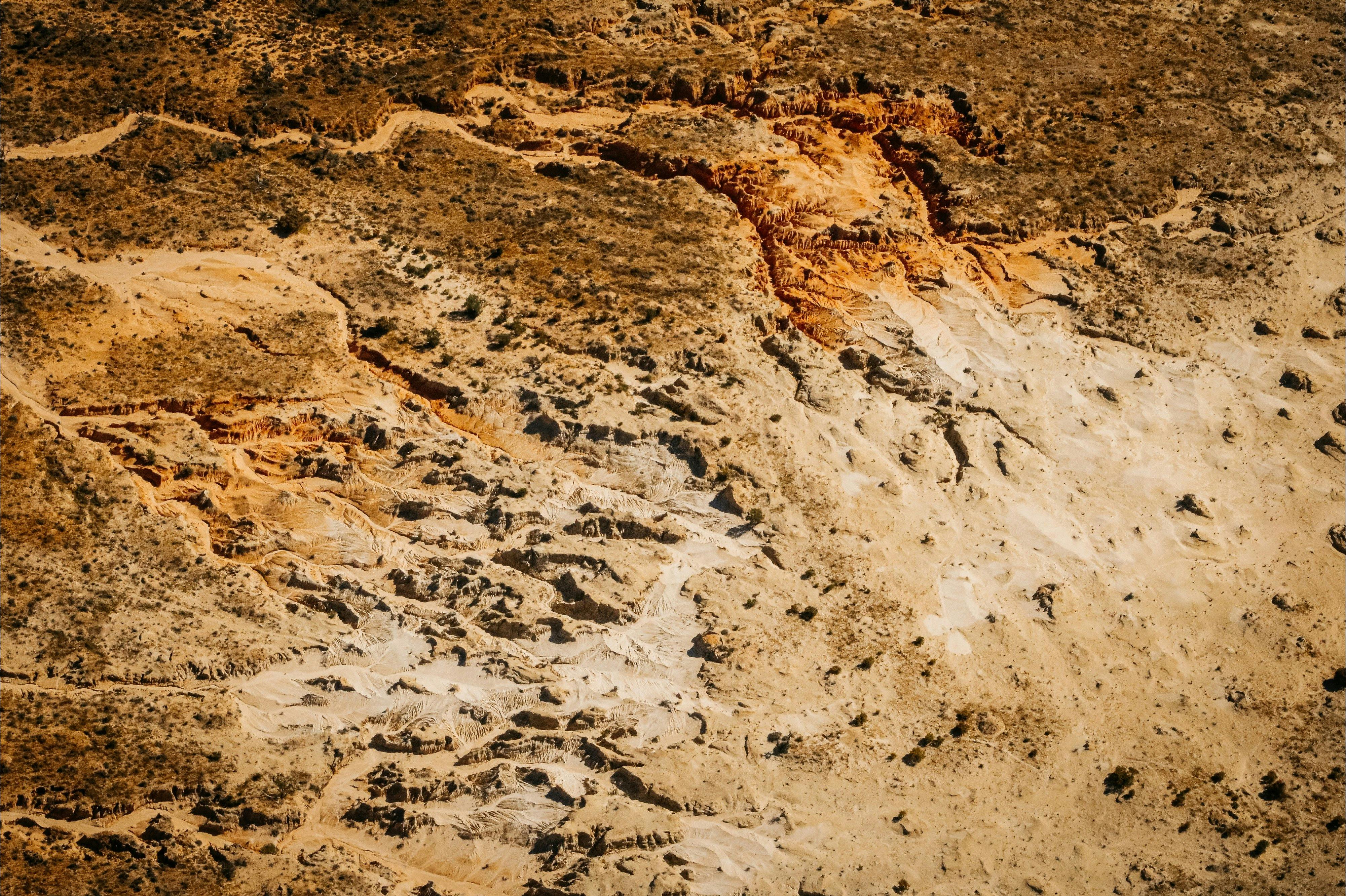 Aerial image of Lake Mungo sand dunes and pinnacles golden clay and pale sand coloured.