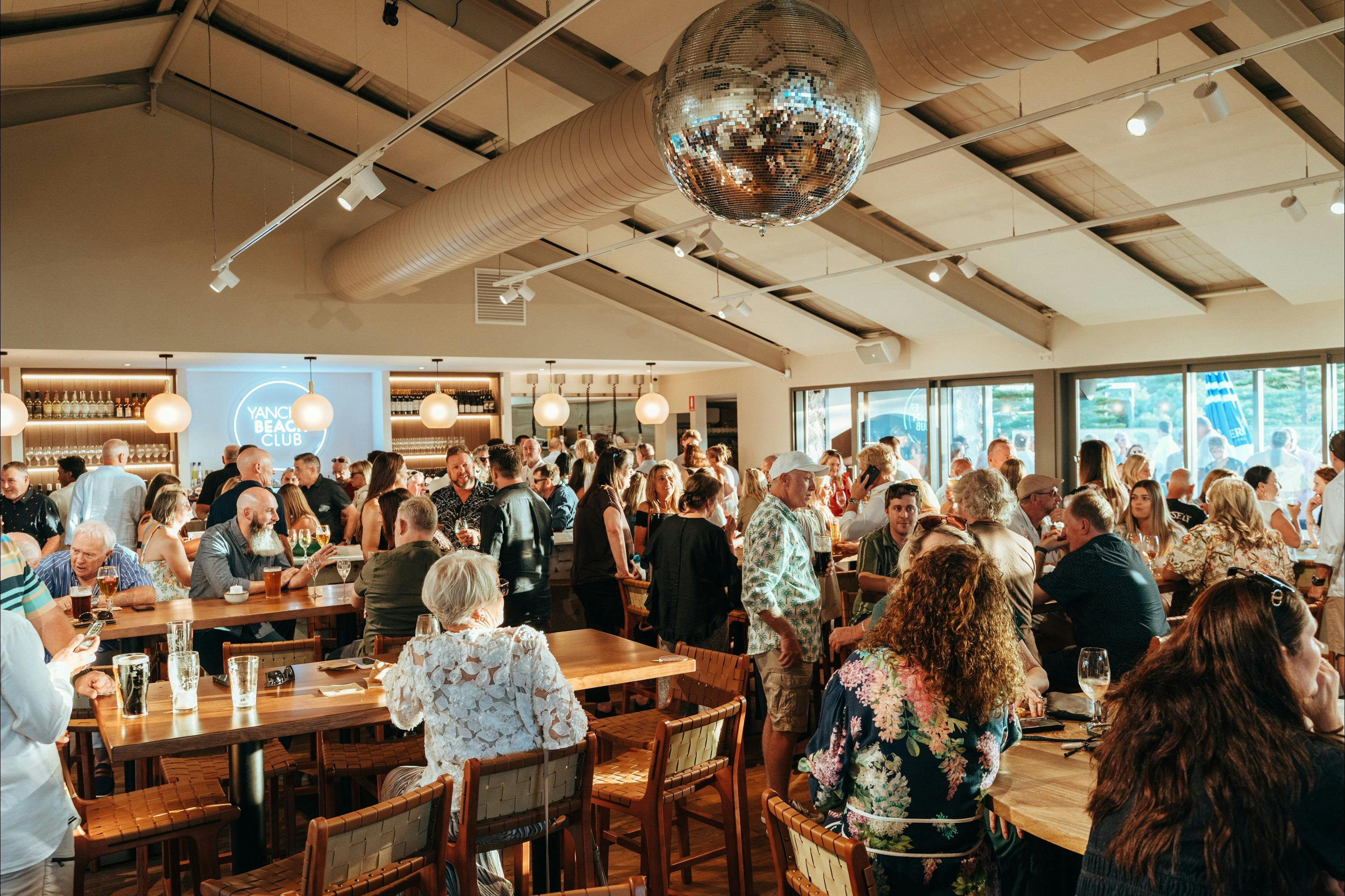 Bustling crowd inside Yanchep Beach Club under a disco ball