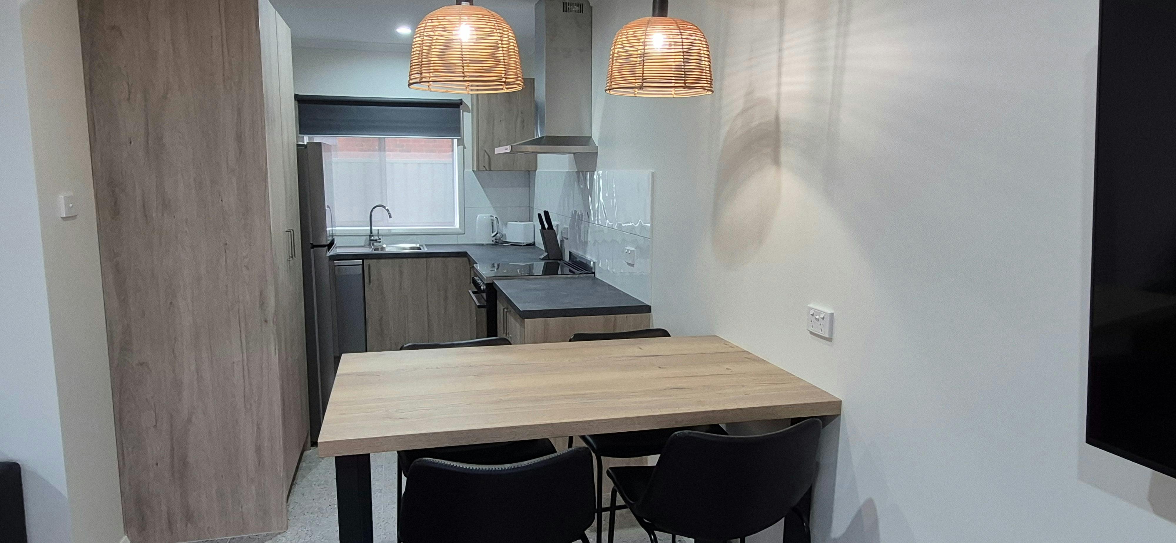 Kitchen equipped with dishwasher, oven, coffee pod machine, breakfast table