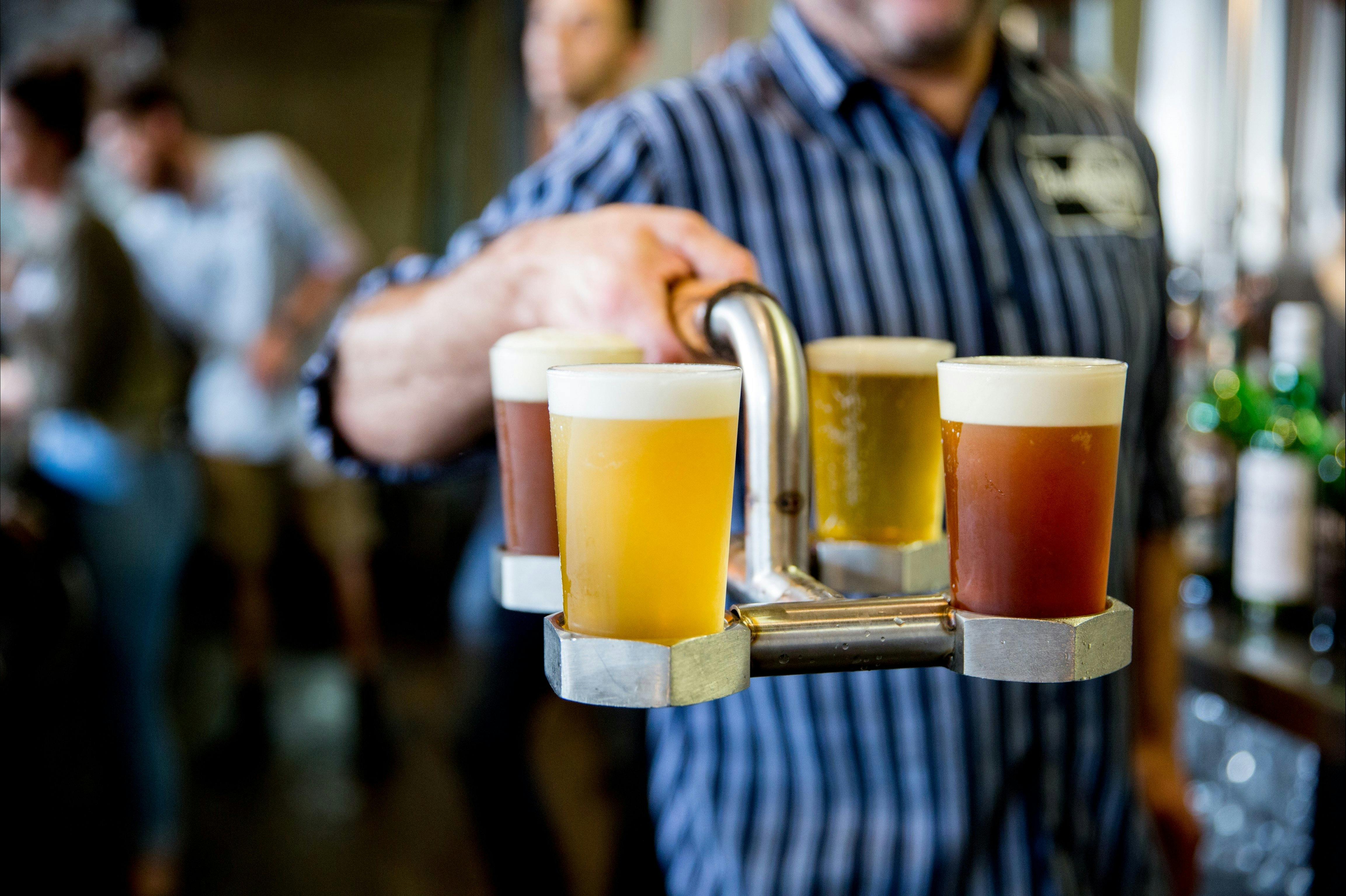 Person holding a tray of beer