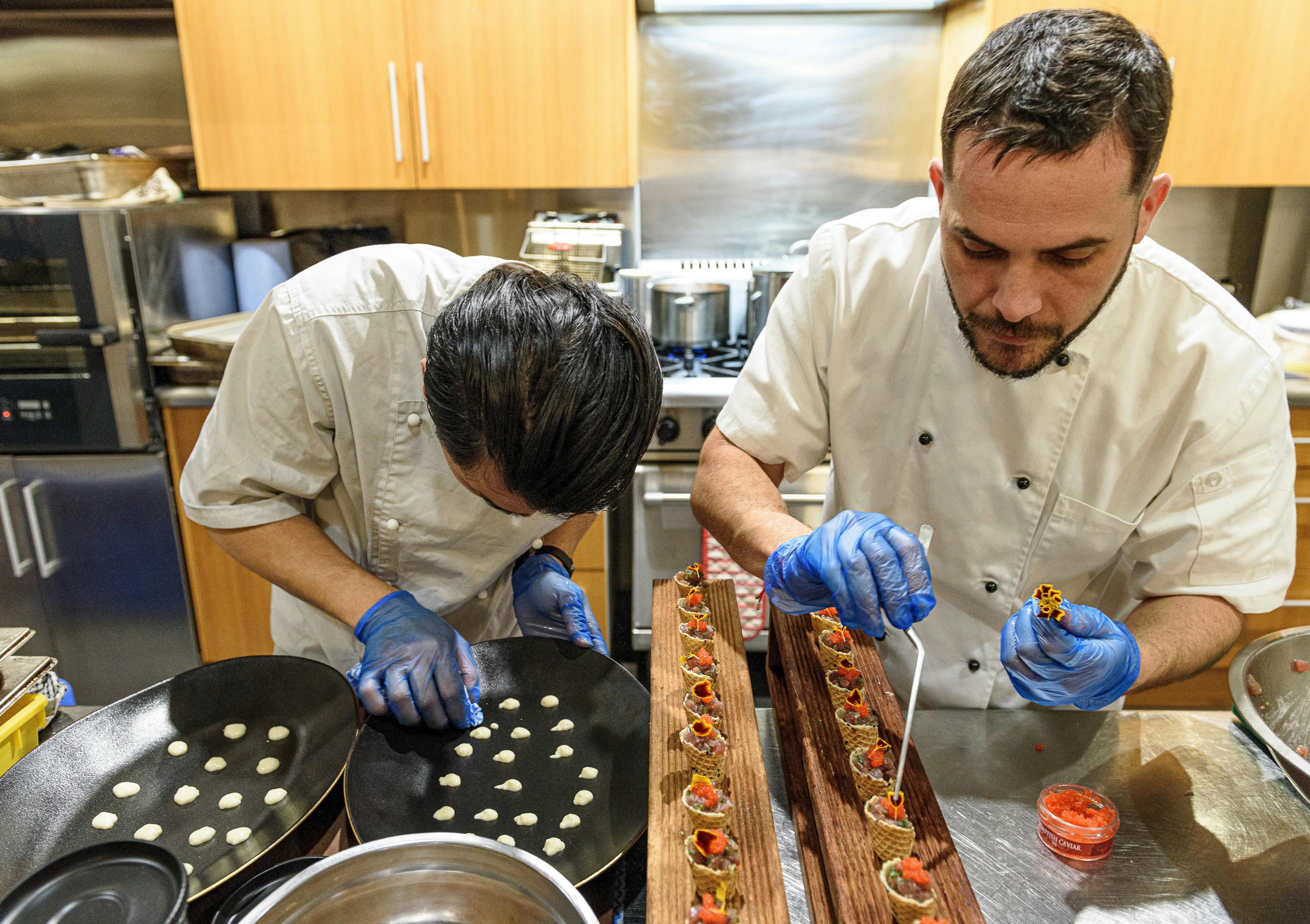 Chefs preparing delicate canapes in Table House kitchen