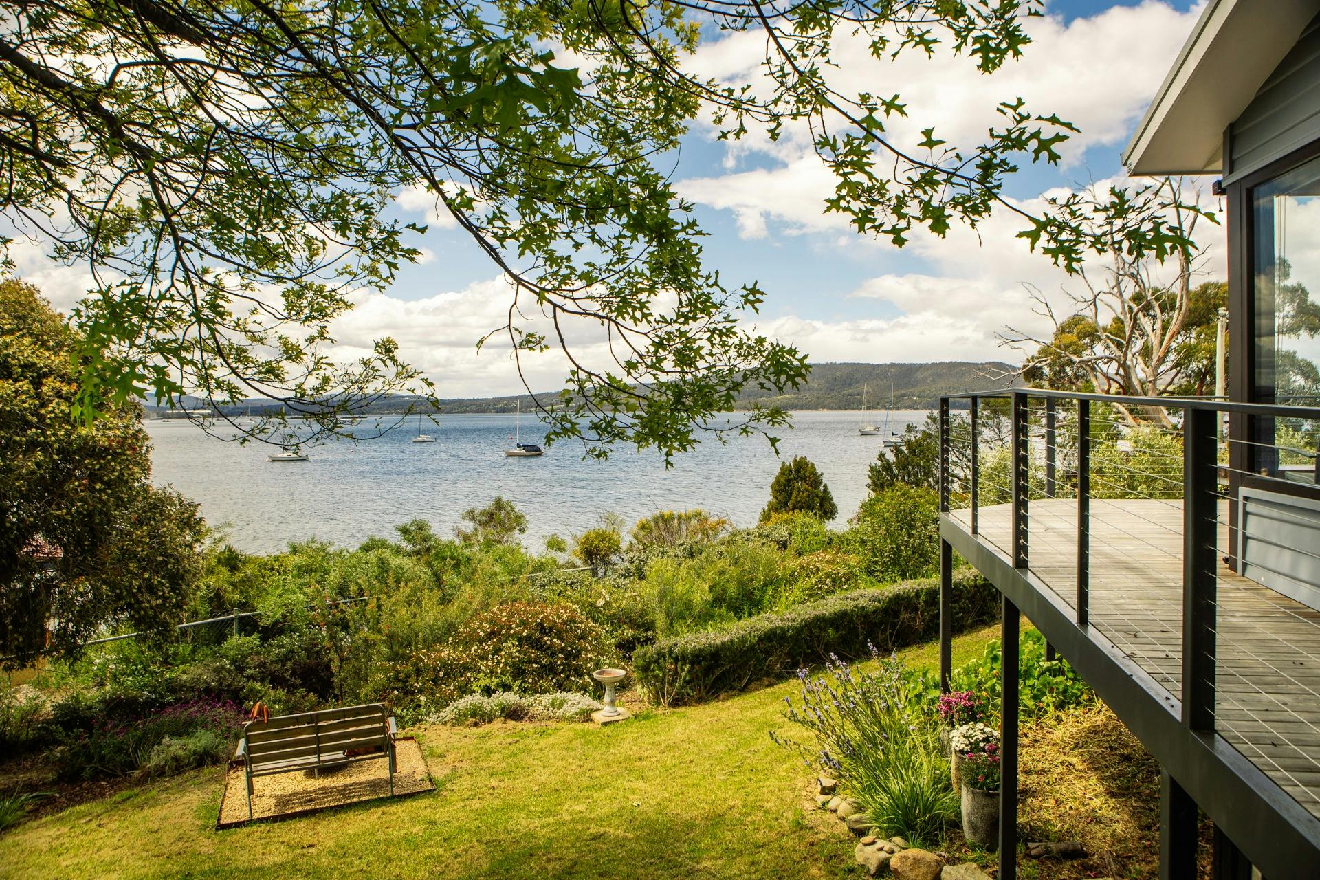 Garden and sea view from Deck outside Master bedroom at Snug on the Bay