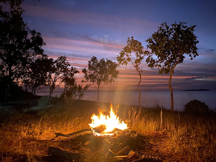 Campfire in middle of Arnhem Land during a purple sunset