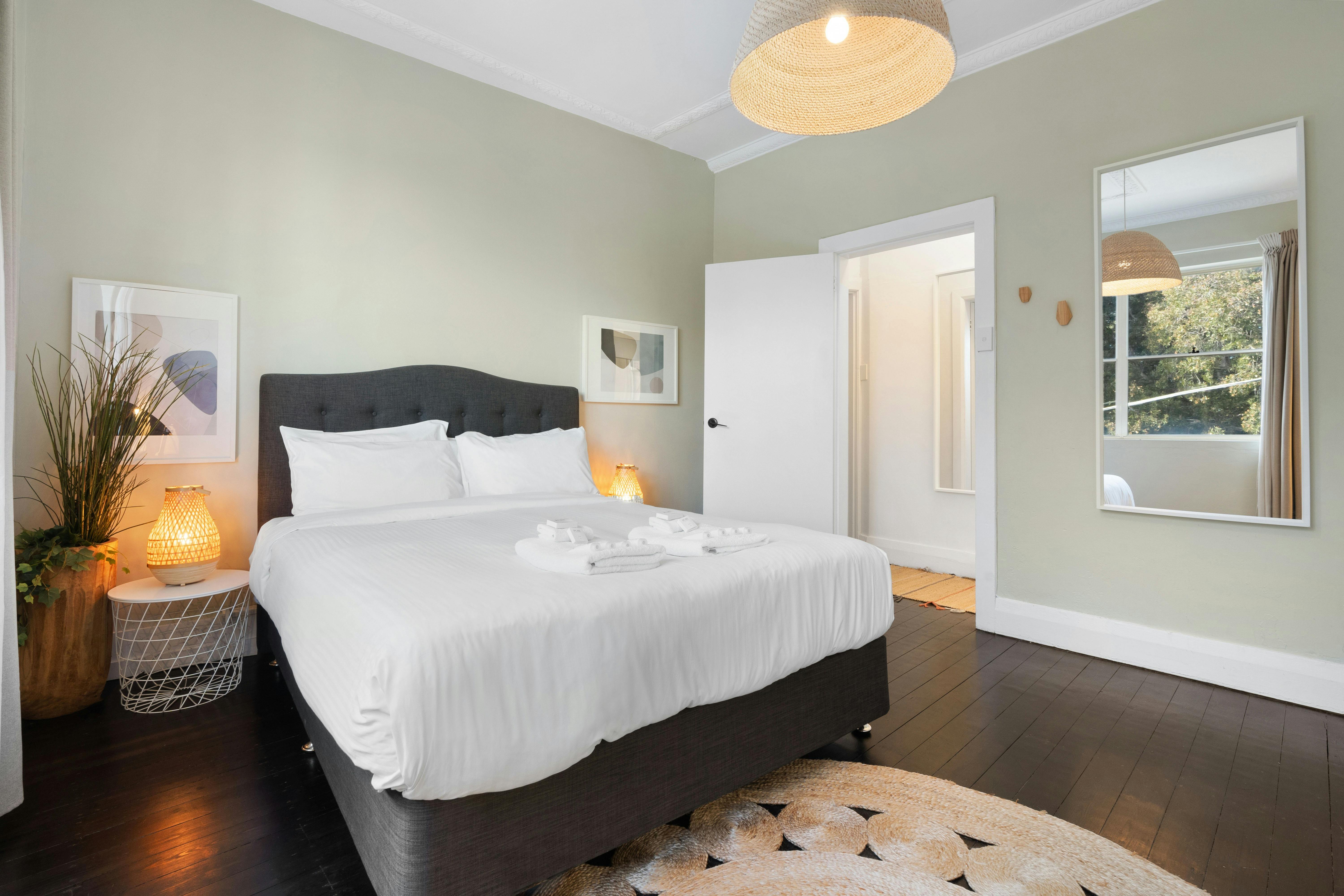 Modern bedroom with stylish decor and a cozy bed with fresh linens.