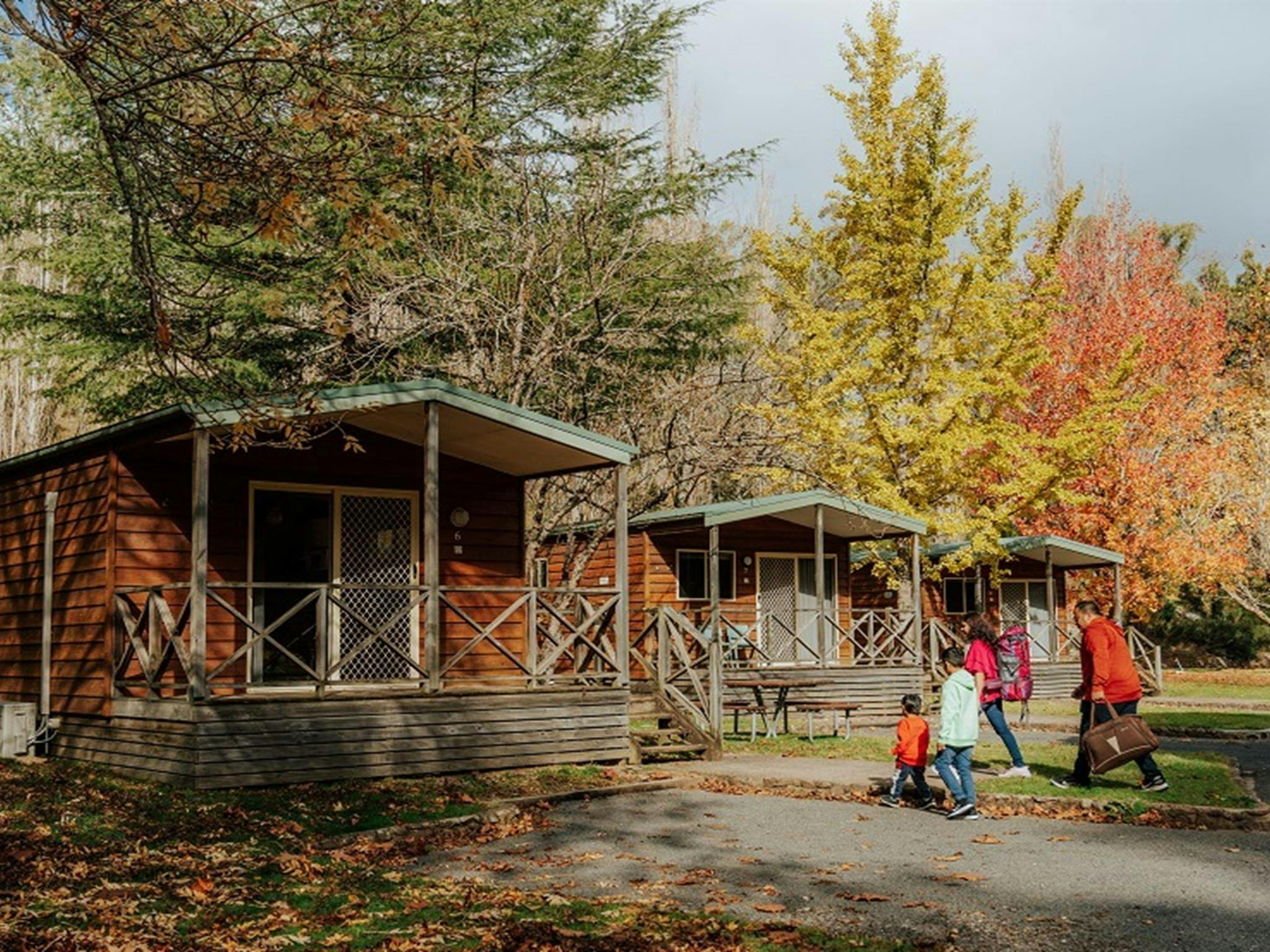 A family group arrive, walking up to Wombeyan Caves cabins, at the start of their stay at Wombeyan