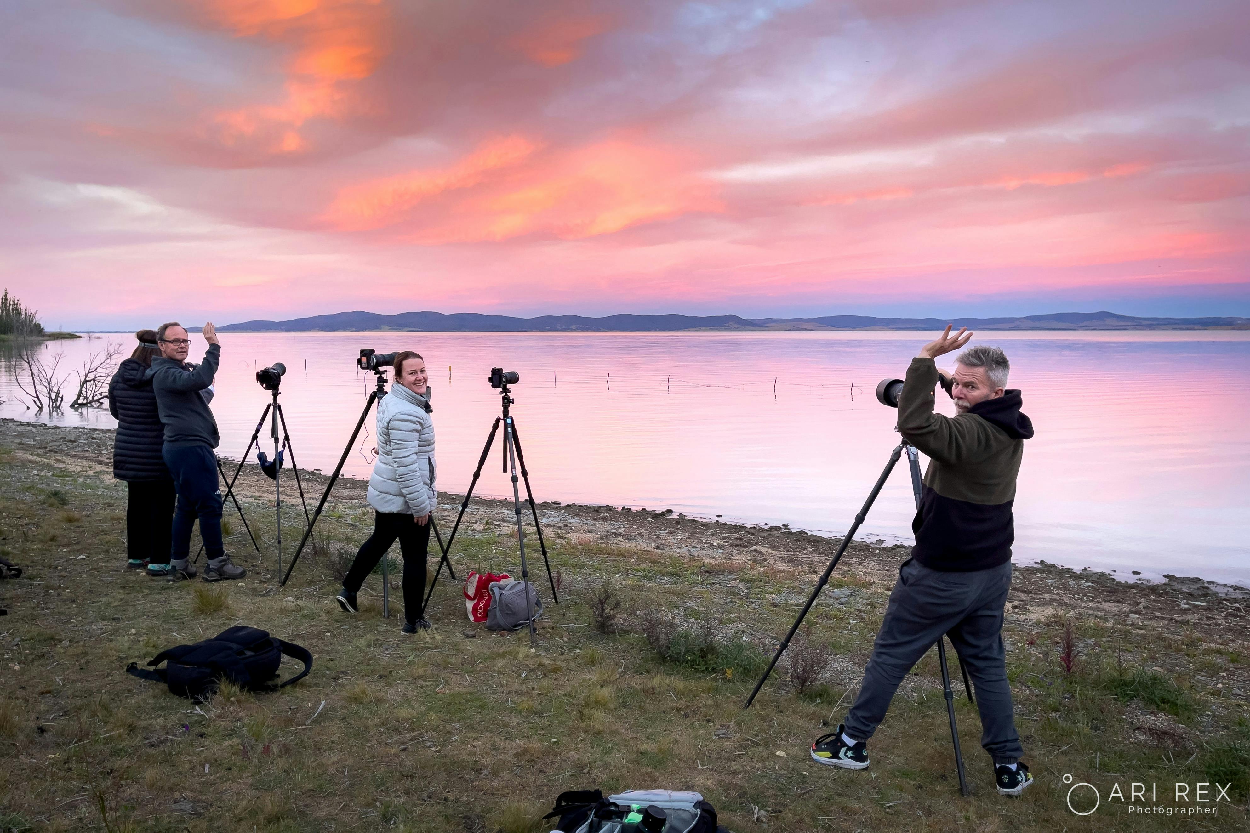 Participants photographing the moon rising over lake George