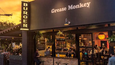 Dark building exterior in front of a sunset