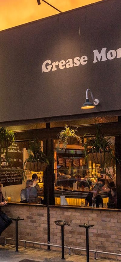 Dark building exterior in front of a sunset