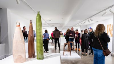 People walking around in a gallery.