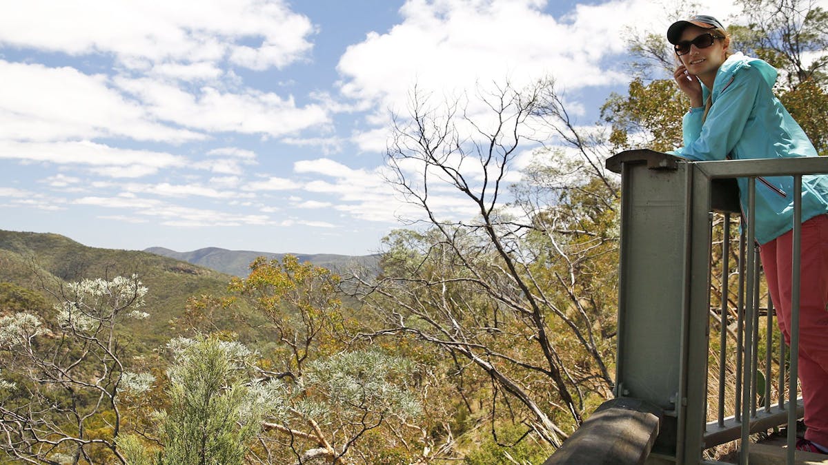 Lady on lookout with view in background.