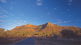 Road leading to jagged peaks.