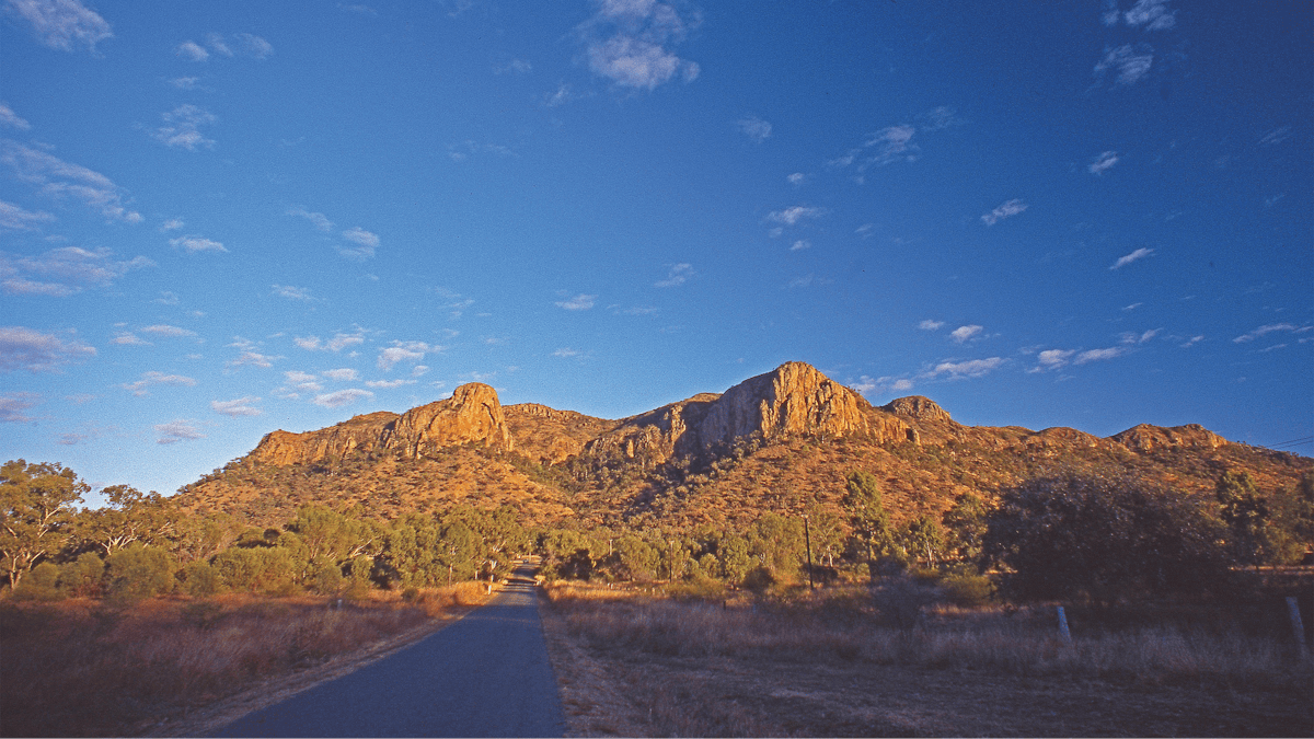 Road leading to jagged peaks.
