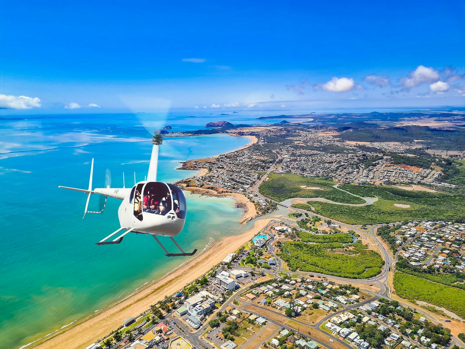 Photo of Yeppoon Central Queensland showing town and coastline with a helicopter Photo of Yeppoon Central Queensland showing town and coastline with a helicopter