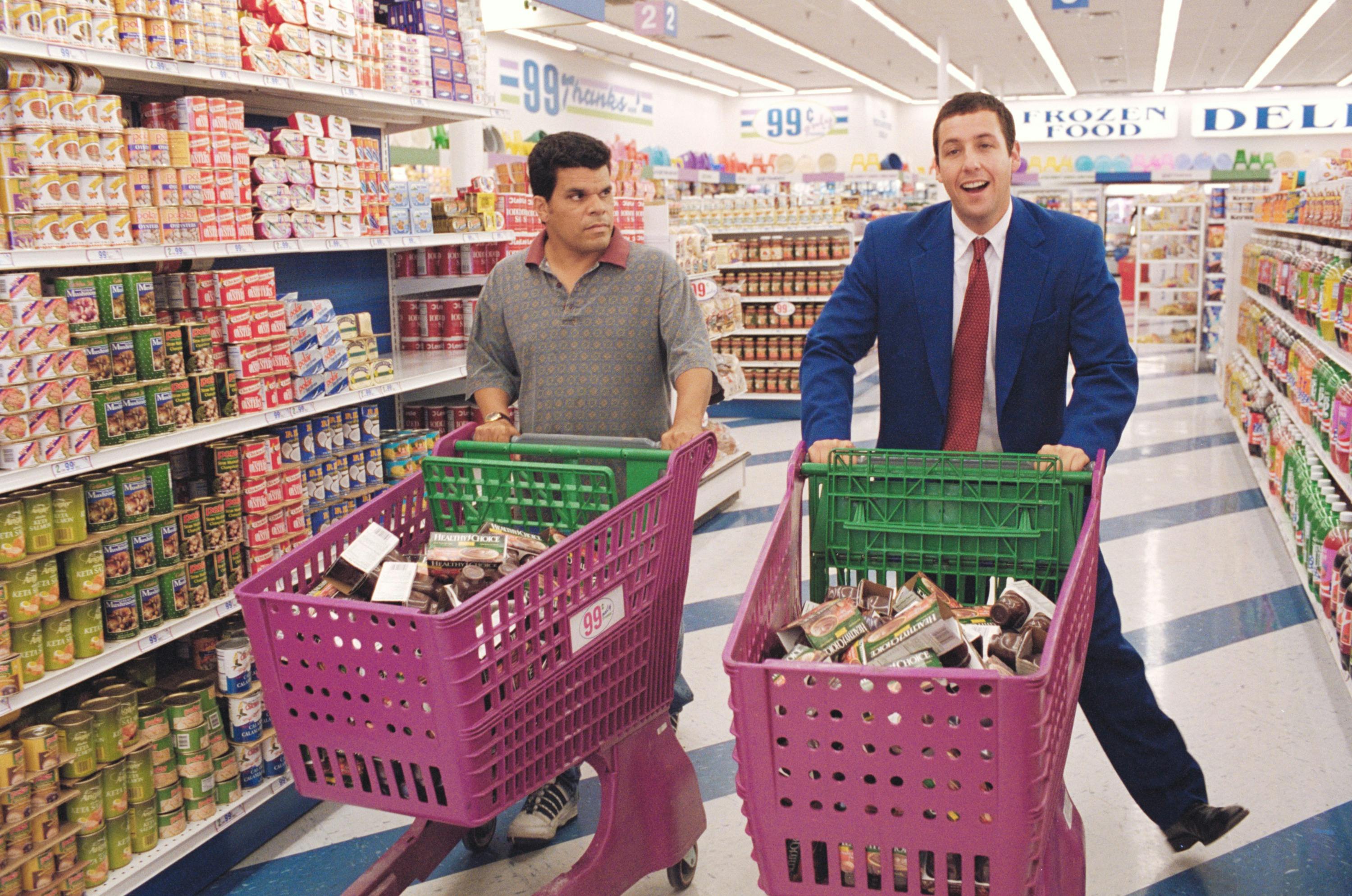 Two men in supermarket with pink shopping trolleys