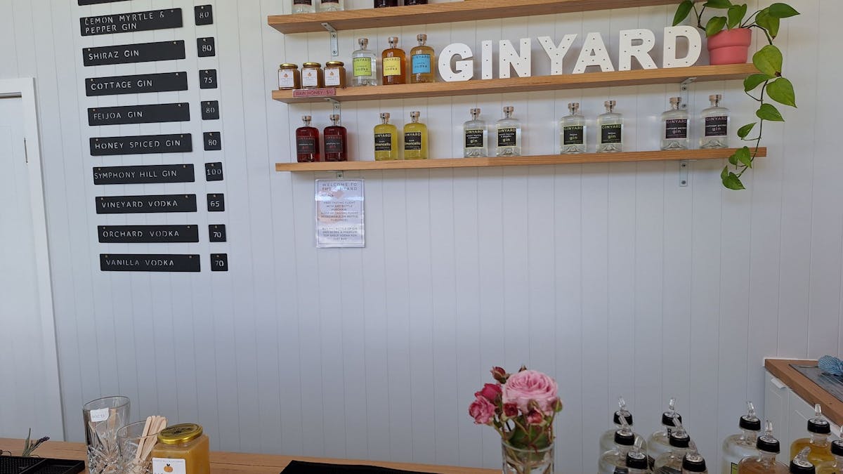 Ginyard bar and shelves showing bottles and menu