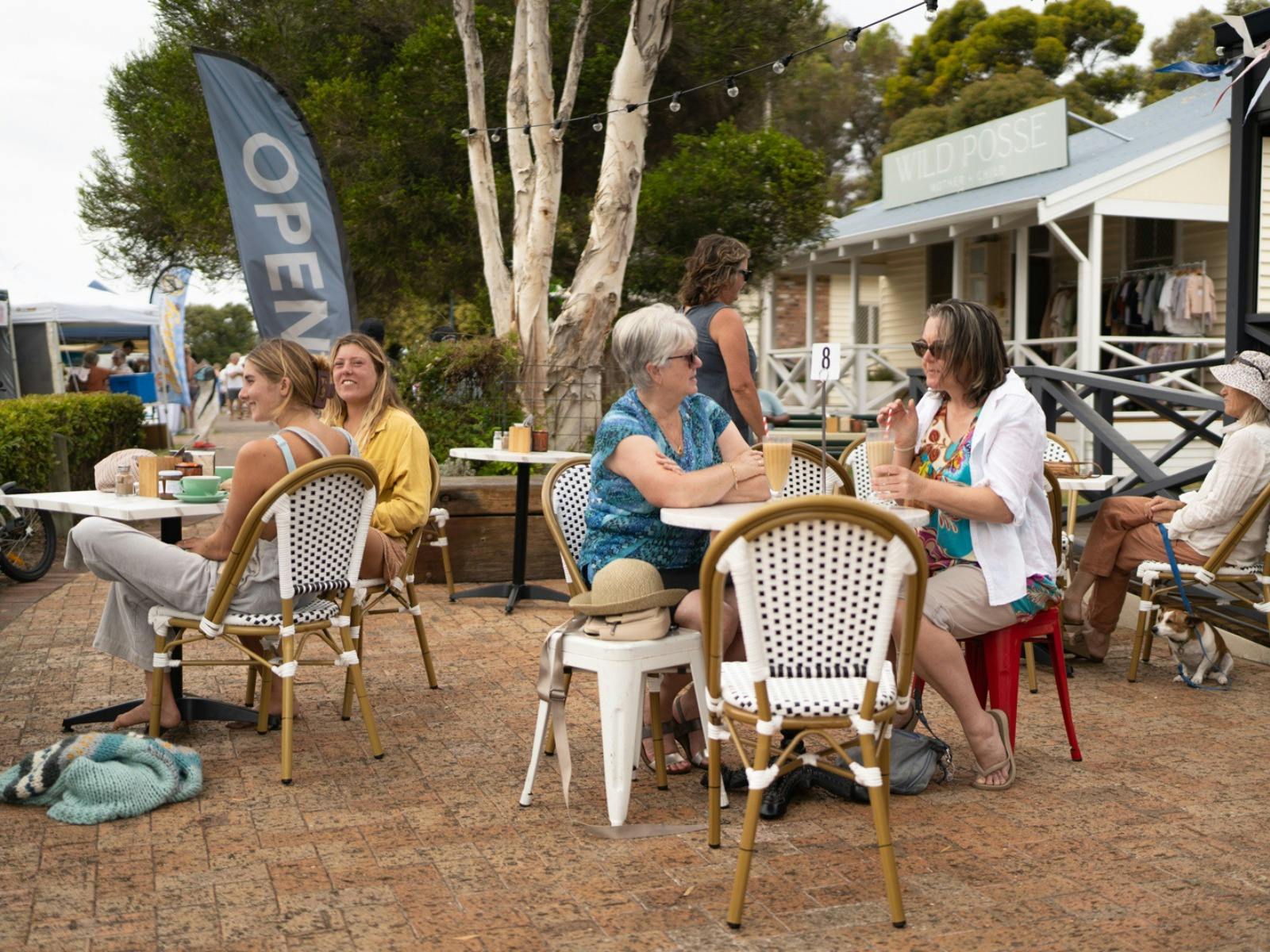people and dogs enjoy the outdoor seating