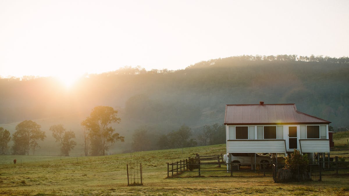 Country House on property with sun setting in background