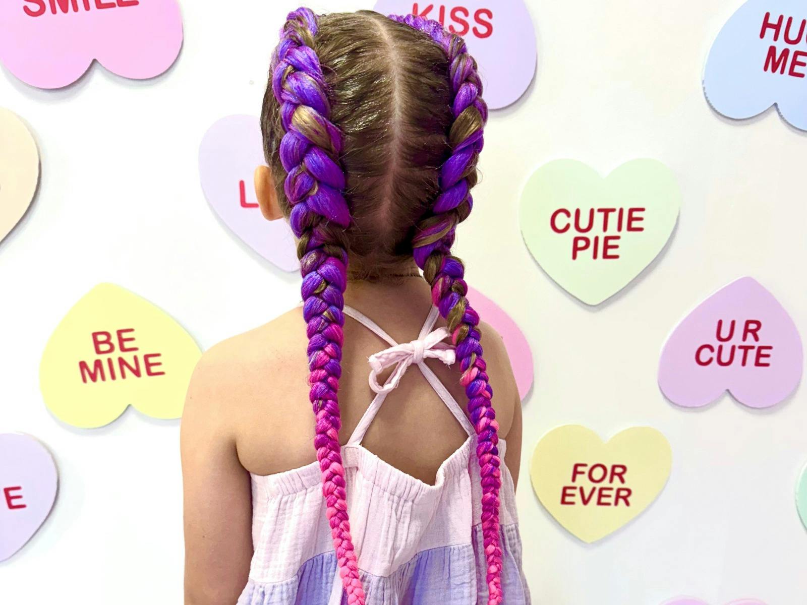 back shot of girl with 2 long hair braids